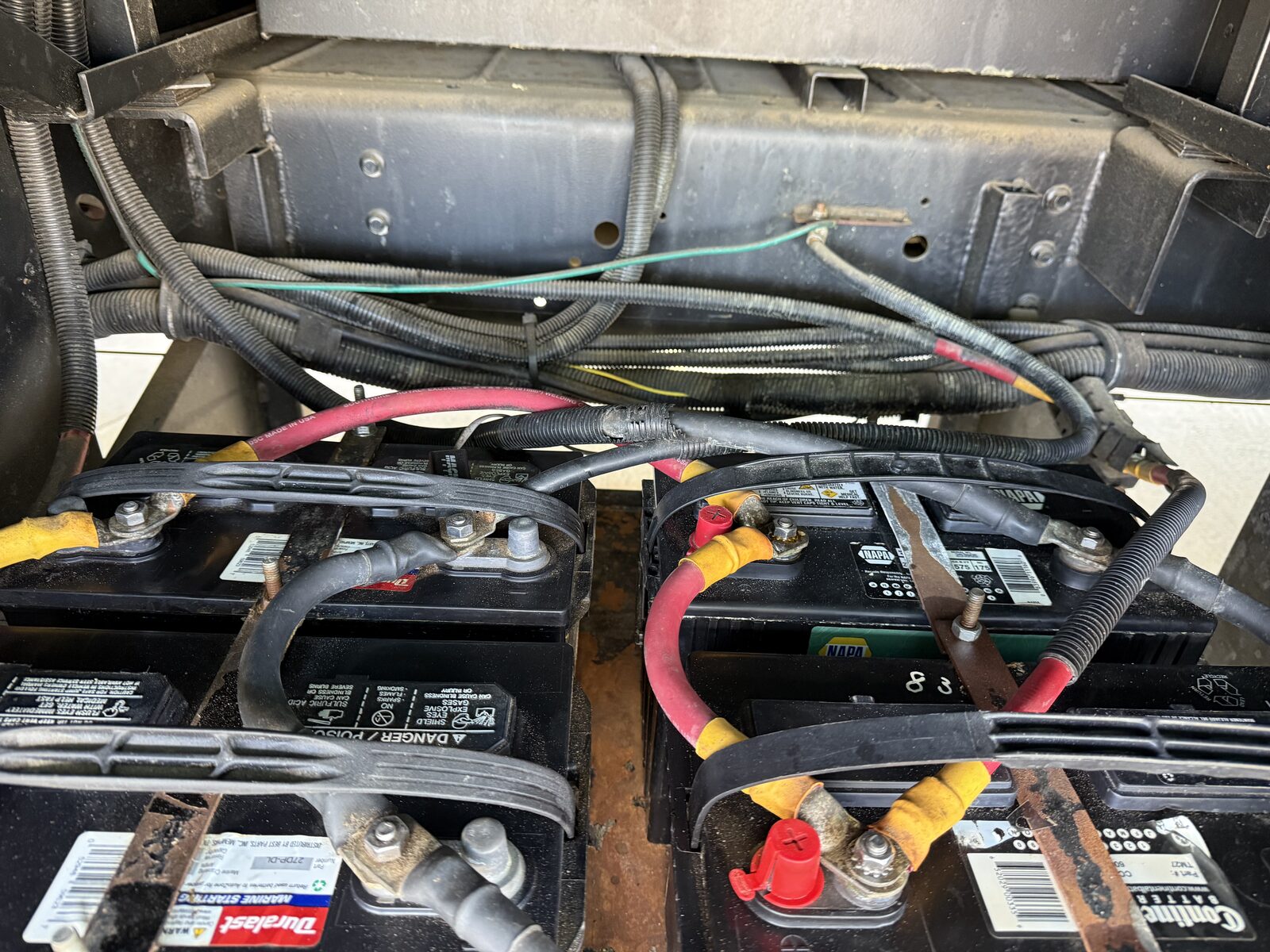 RV chassis battery bank with cleaned terminals and new cable connections