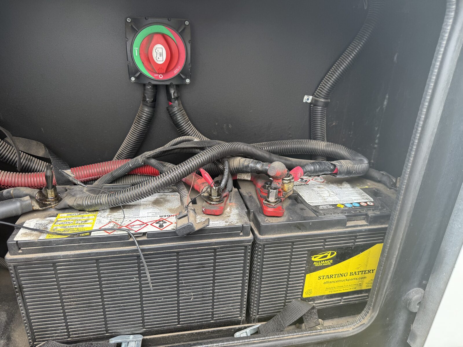 RV house battery compartment with new battery disconnect switch installed
