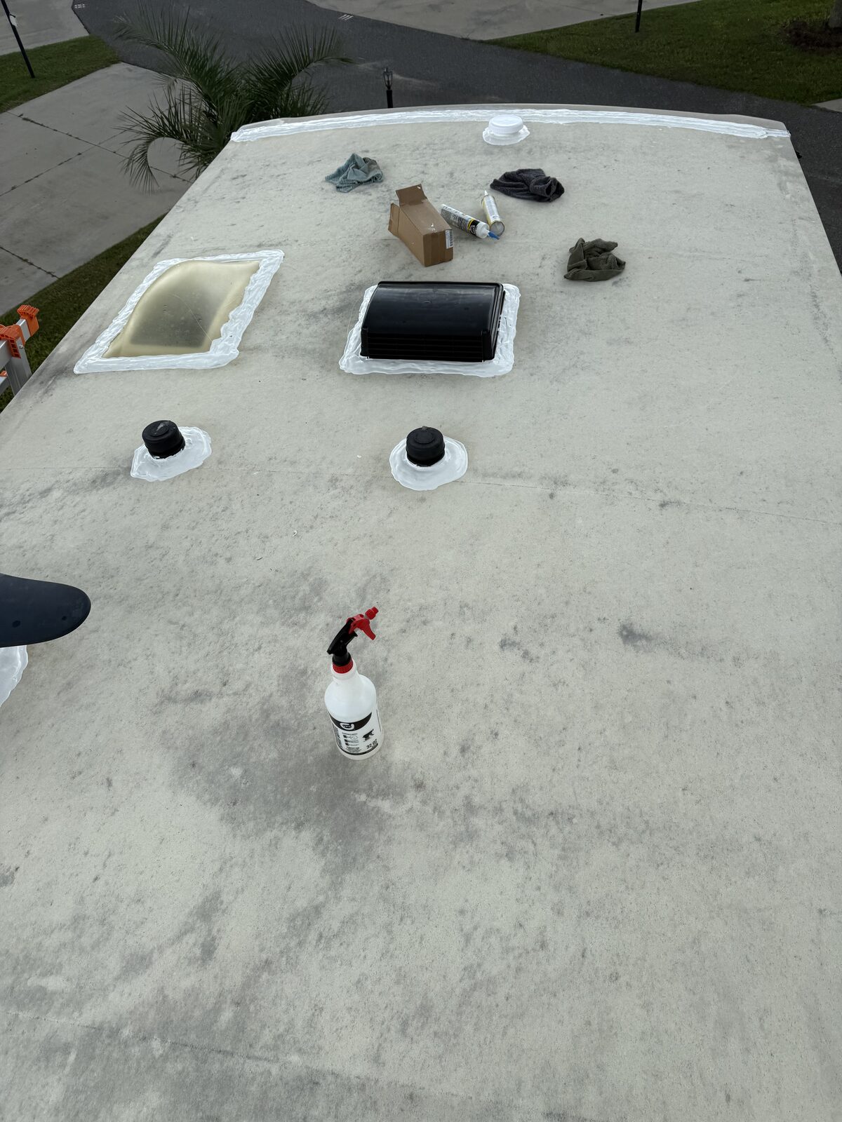 RV roof mid-job during cleaning and resealing of vents